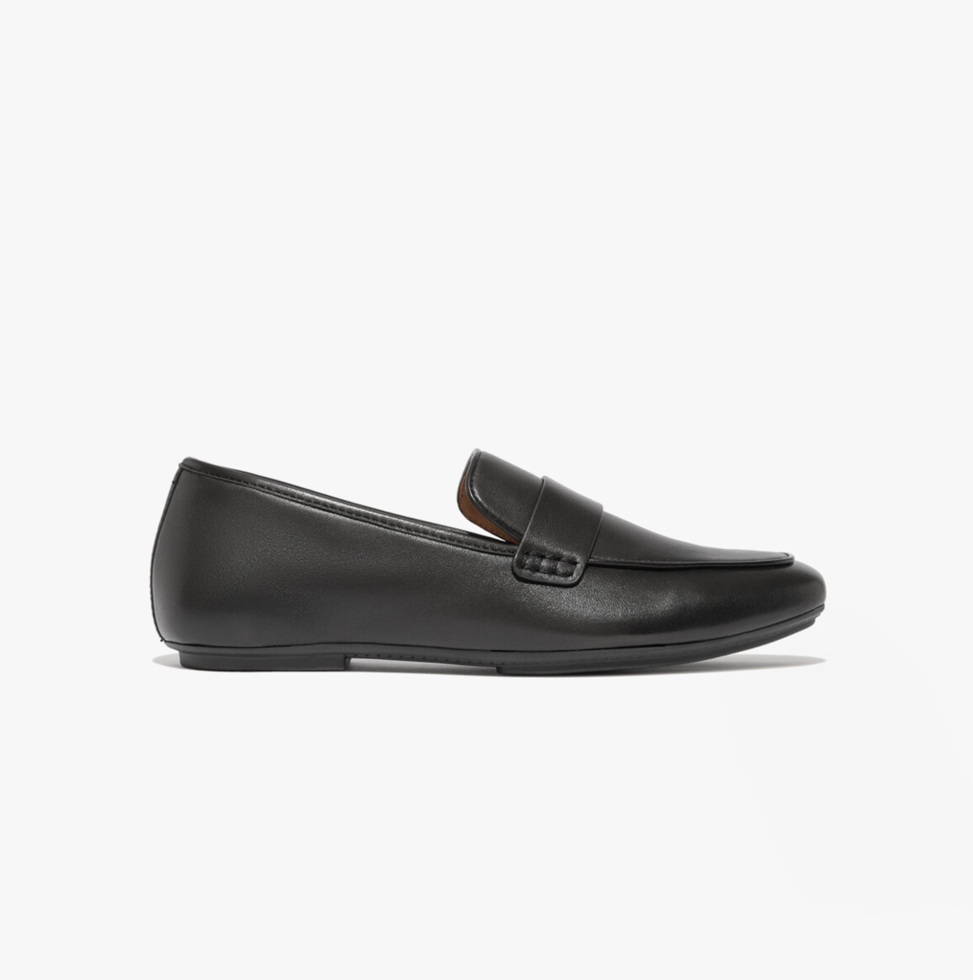 Side view of FitFlop DELICATO SOFT Womens Loafers Black showing leather upper and slip-on design.