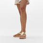 FitFlop LULU LEATHER Womens Toe Post Sandals Platino side view on a model's feet with a short dress.