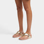 FitFlop LULU LEATHER Womens Toe Post Sandals Platino side view on model's feet, showcasing the leather upper and slip-on style.