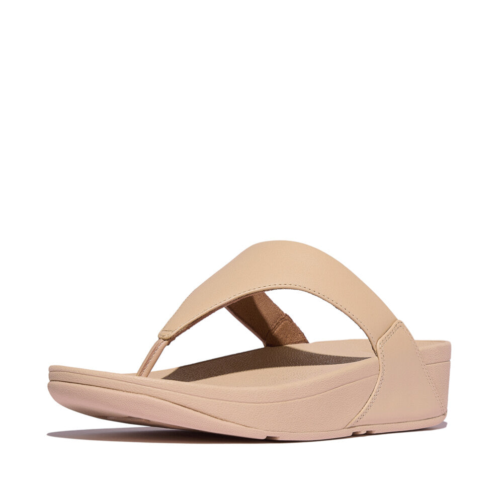 Side view of FitFlop LULU LEATHER Womens Toe Post Sandals Sandy Beige with a low platform heel and slip-on design.