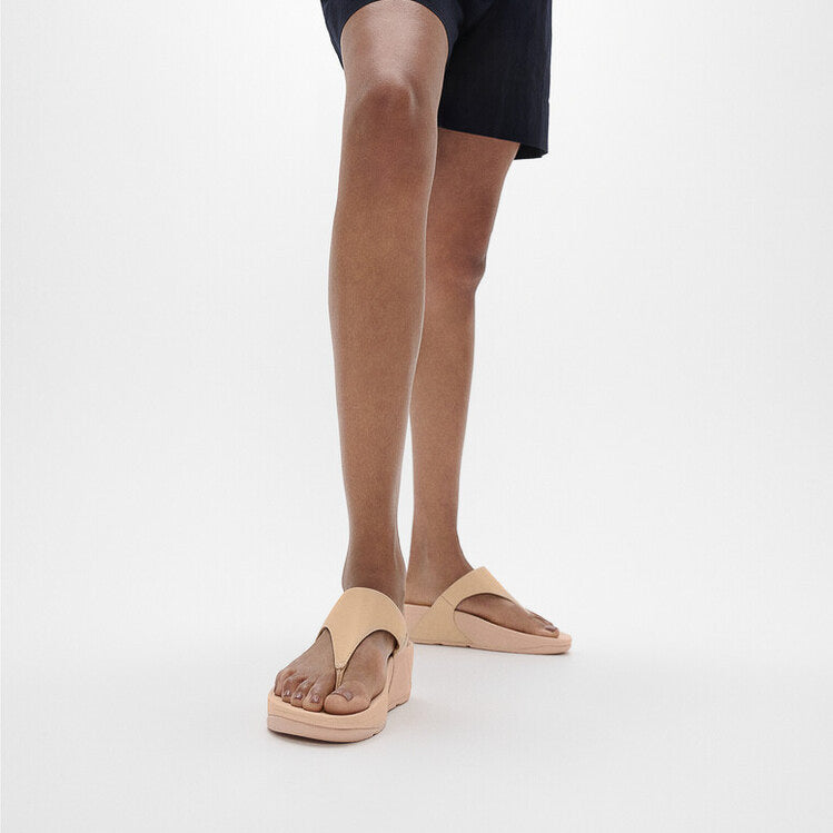 FitFlop LULU LEATHER Womens Toe Post Sandals Sandy Beige side view on a model's feet showing arch support and comfort.