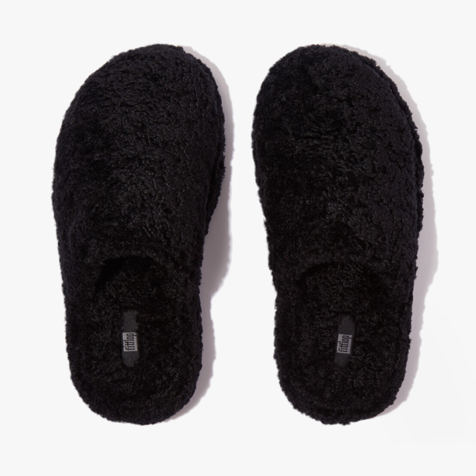 FitFlop iQUSHION D-LUXE Womens Mule Slippers All Black top view showing plush texture and round toe shape.