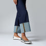 FitFlop DELICATO BOW SOFT Womens Ballet Flats Silver side view worn with dark jeans, showcasing the shoe's sleek design.