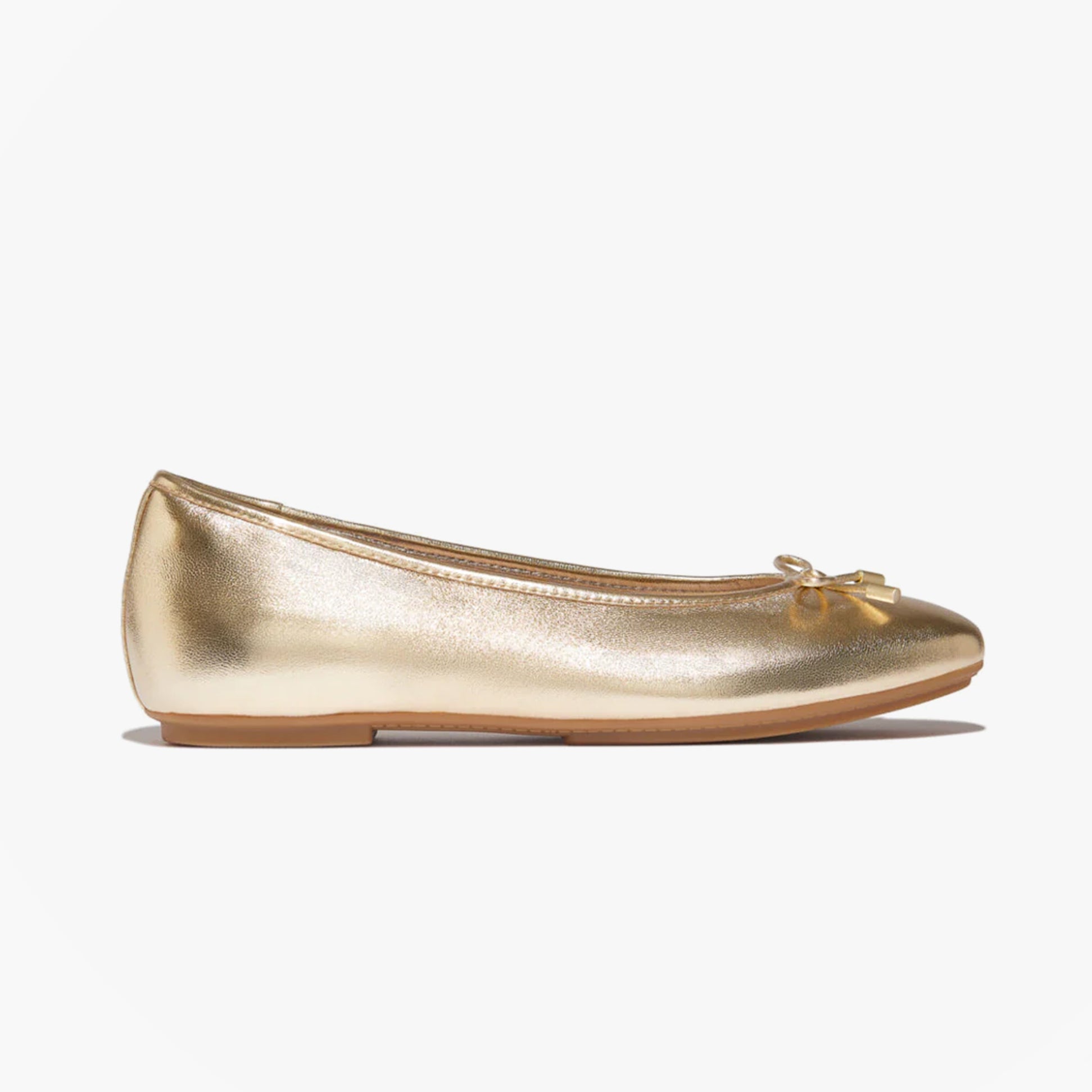 FitFlop DELICATO BOW SOFT Womens Ballet Flats Platino side view with a shiny gold leather upper and a bow detail.