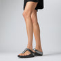FitFlop FINO GLITTERDUST METALLIC Womens Toe Post Sandals Pewter side view on model wearing a black dress.