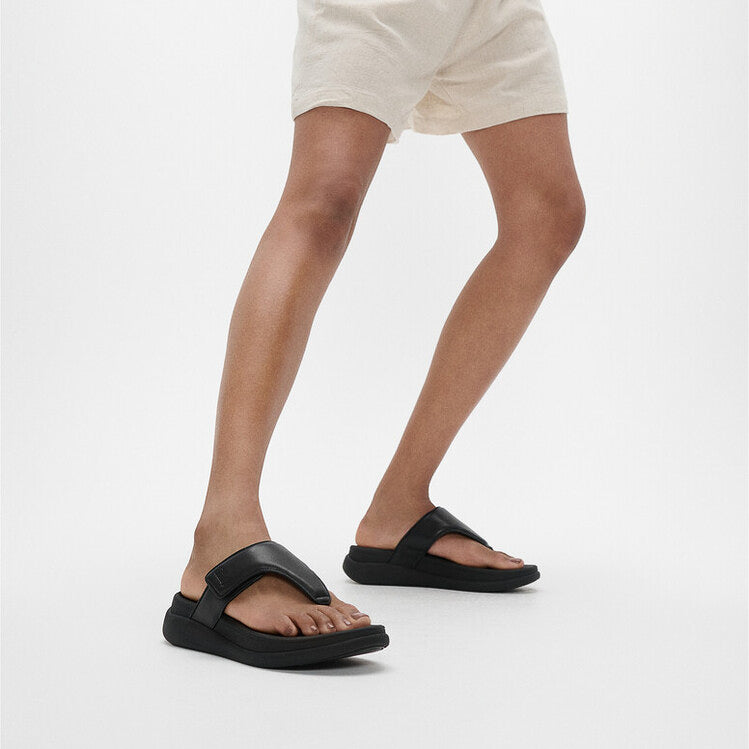 FitFlop F-MODE GO Womens Toe Post Sandals All Black side view worn on feet with a casual outfit
