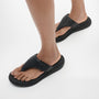 FitFlop F-MODE GO Womens Toe Post Sandals All Black side view on a model's feet showcasing comfort and style.