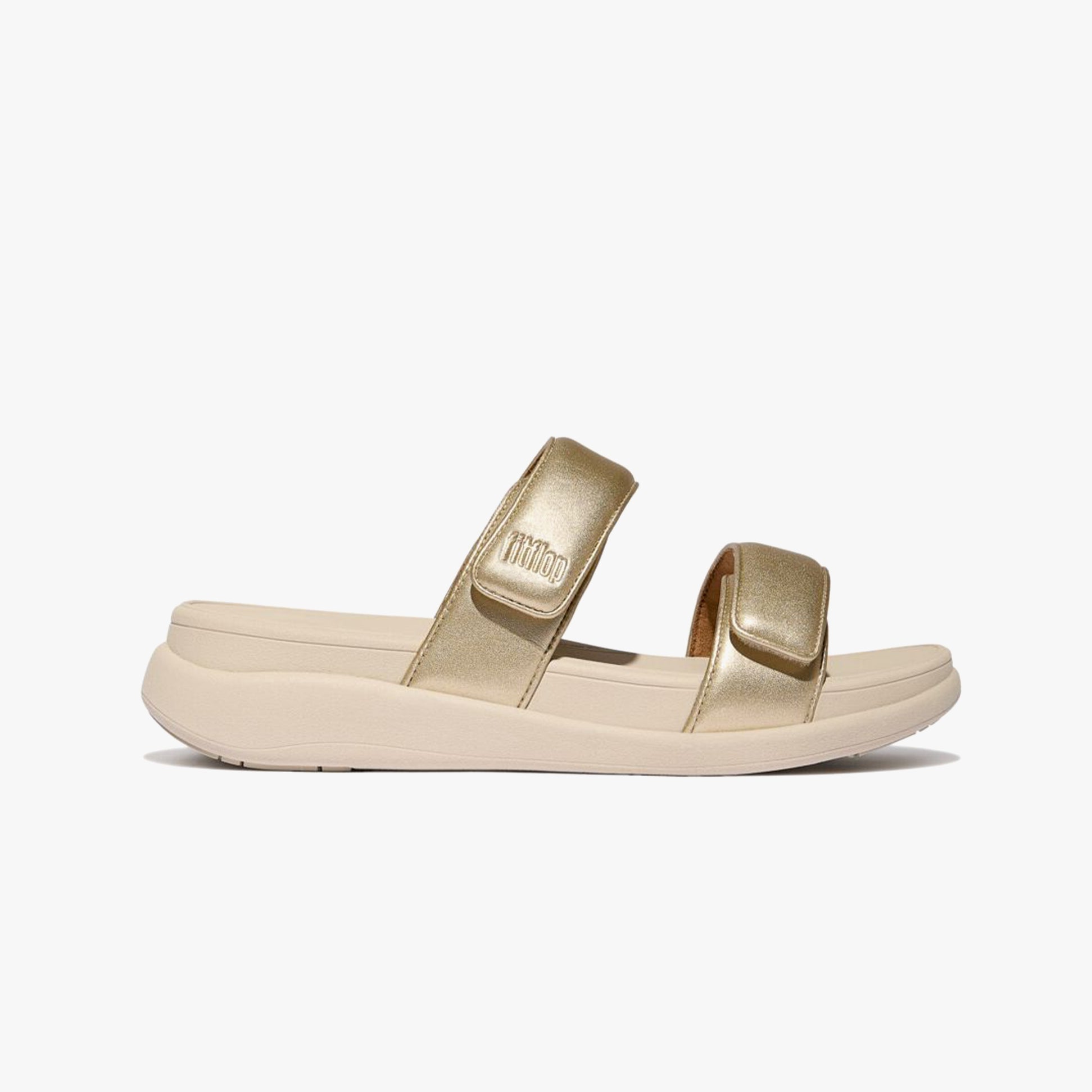 FitFlop F-MODE GO Womens Slides Platino side view showcasing the comfortable slip-on design with leather straps.
