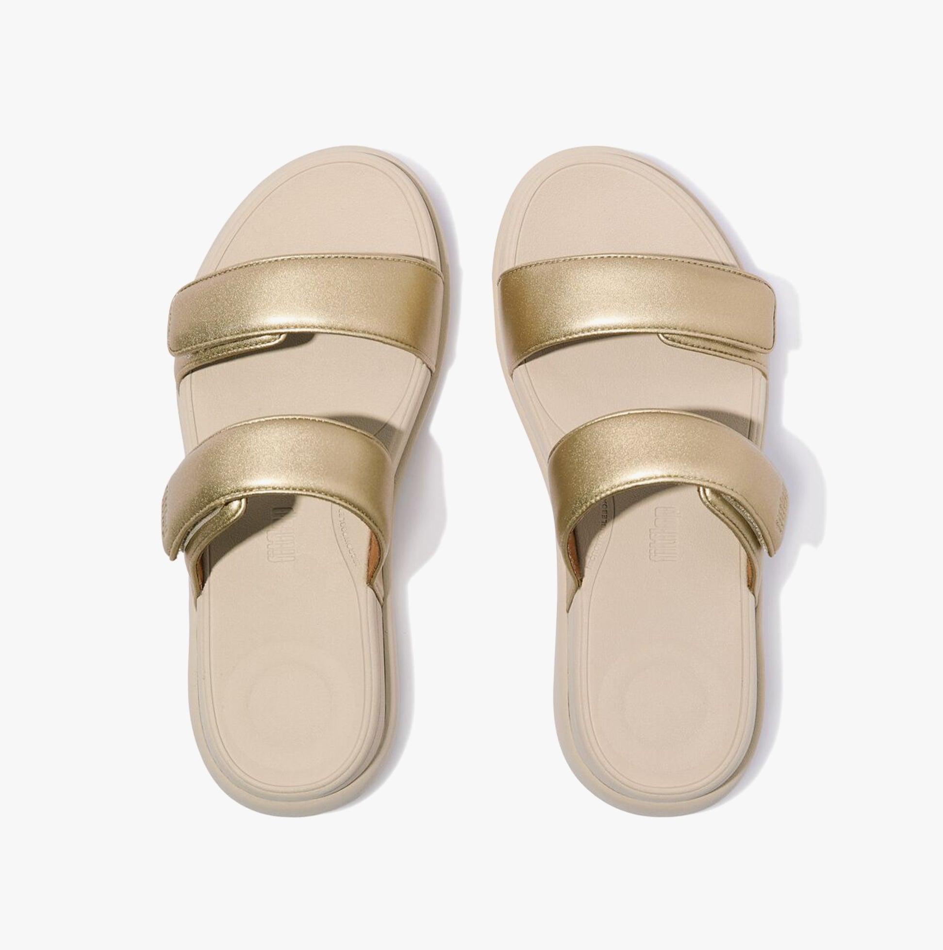 FitFlop F-MODE GO Womens Slides Platino top view showcasing gold leather straps and soft EVA sole.