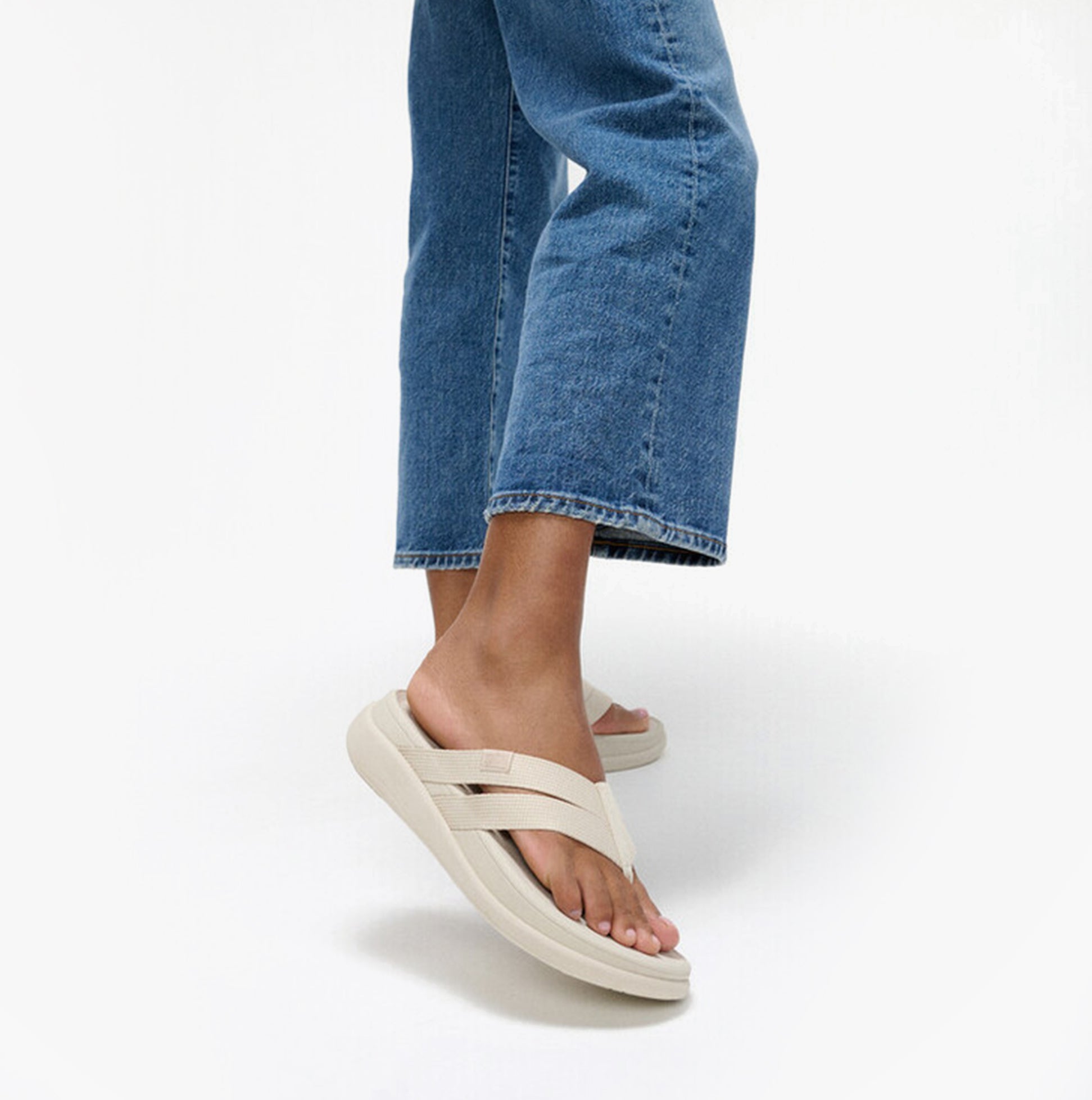 FitFlop F-MODE GO Womens Flip Flops Paris Beige side view worn with denim jeans.