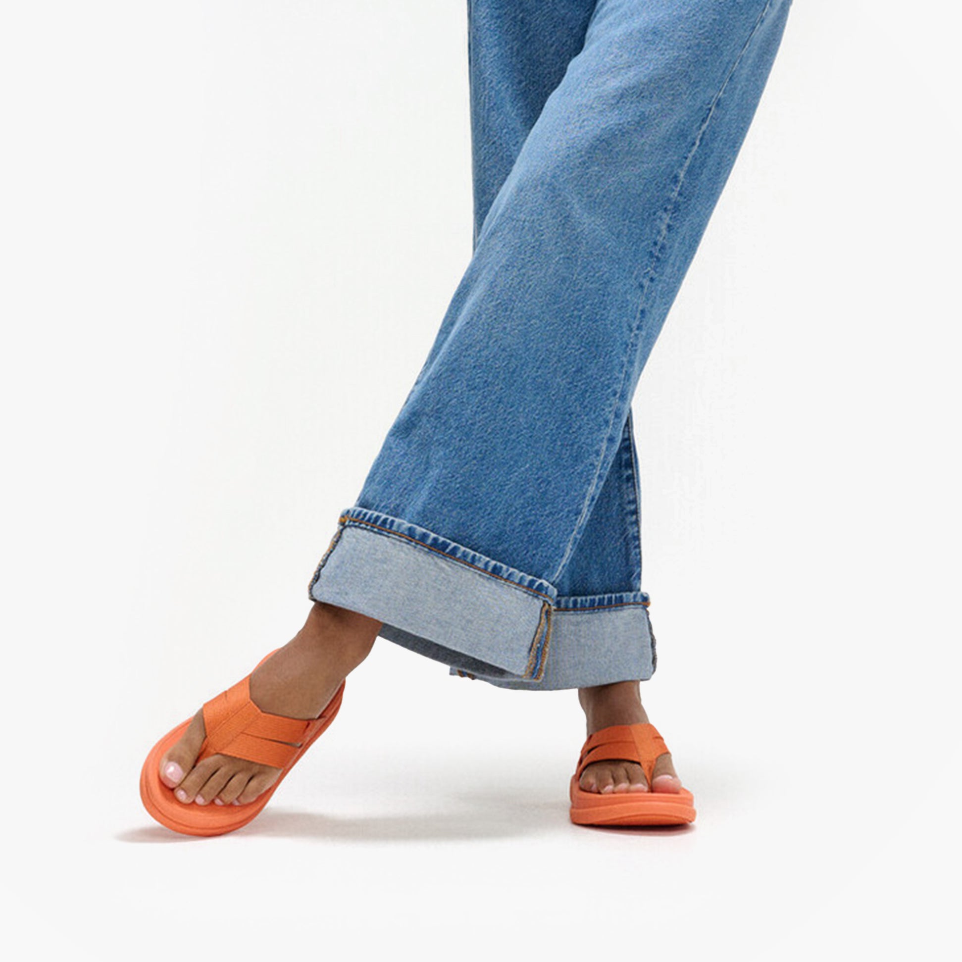 FitFlop F-MODE GO Womens Flip Flops Satsuma side view worn with wide-leg jeans.