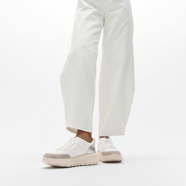 FitFlop F-MODE LEATHER Womens Trainers Urban White/Silver side view on model with white pants.