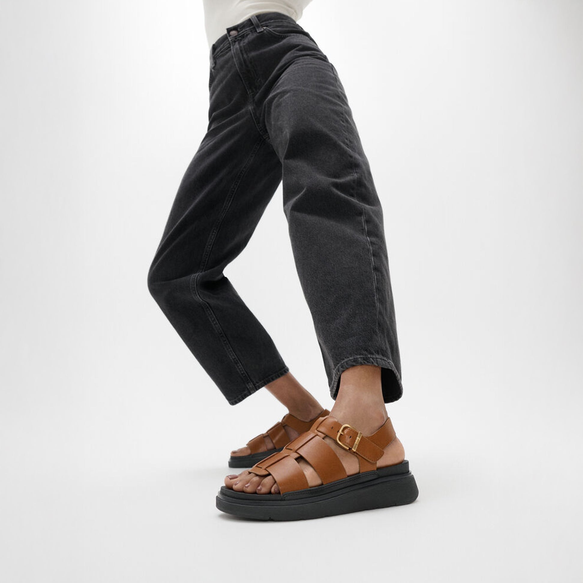 FitFlop GEN-FF LEATHER Womens Fisherman Sandals Deep Tan side view worn with black jeans.