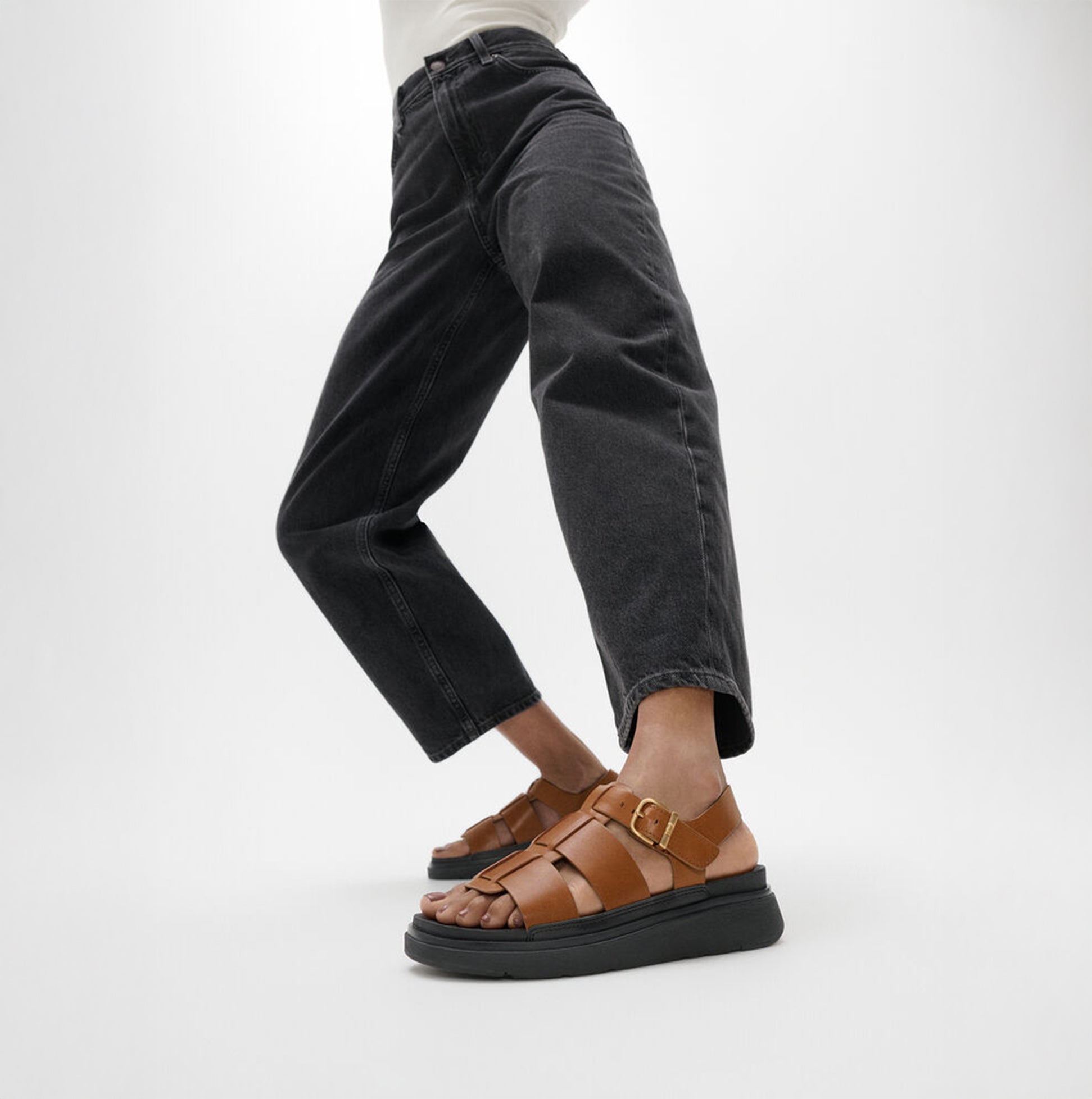 FitFlop GEN-FF LEATHER Womens Fisherman Sandals Deep Tan side view worn with black jeans.