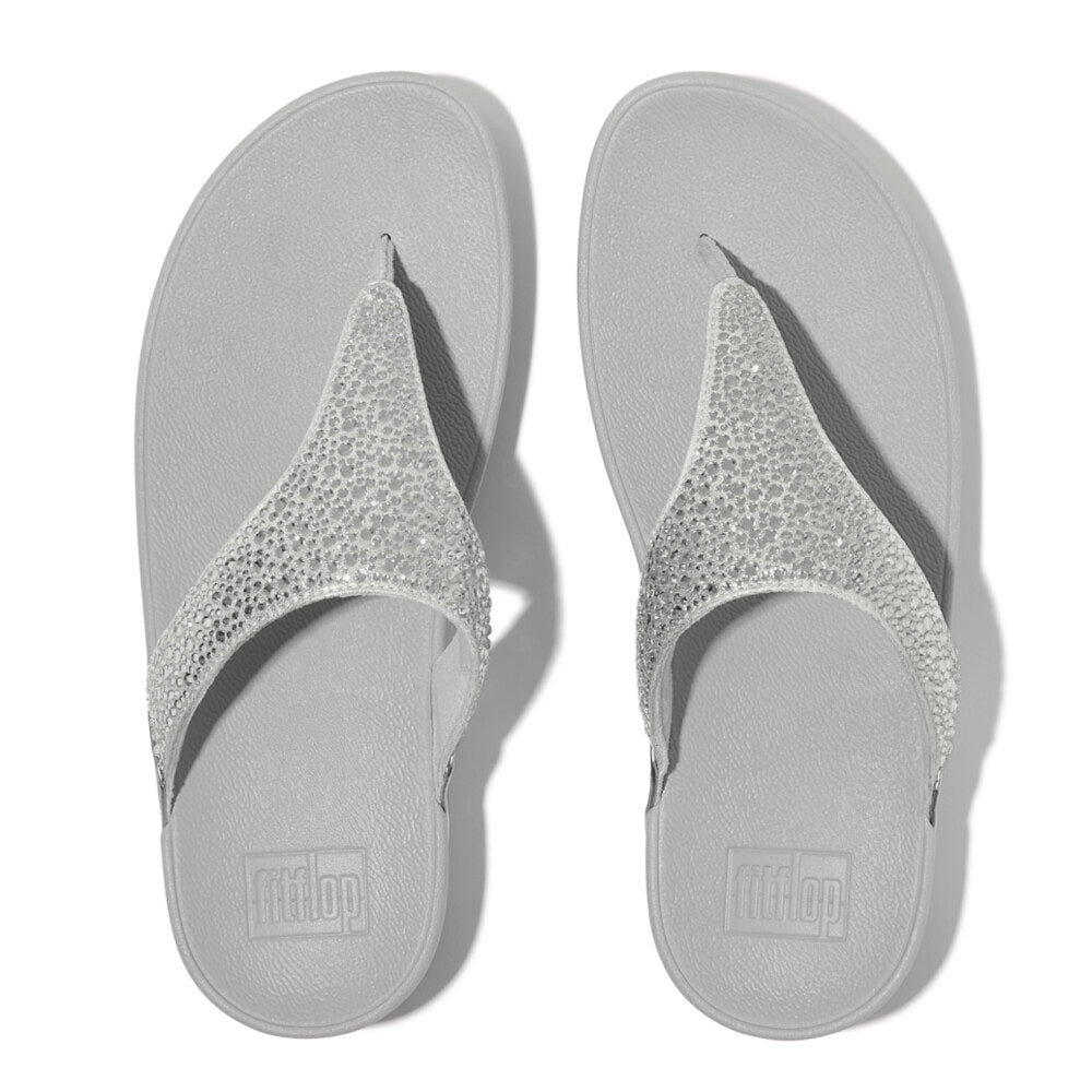 FitFlop LULU CRYSTAL-MIX Womens Toe Post Sandals Silver top view displaying the glittering toe post design on a grey sole.