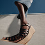 FitFlop PLATFFORMS ESPADRILLE Womens Wedge Sandals Black side view with a model showcasing the wedge heel and strappy design.