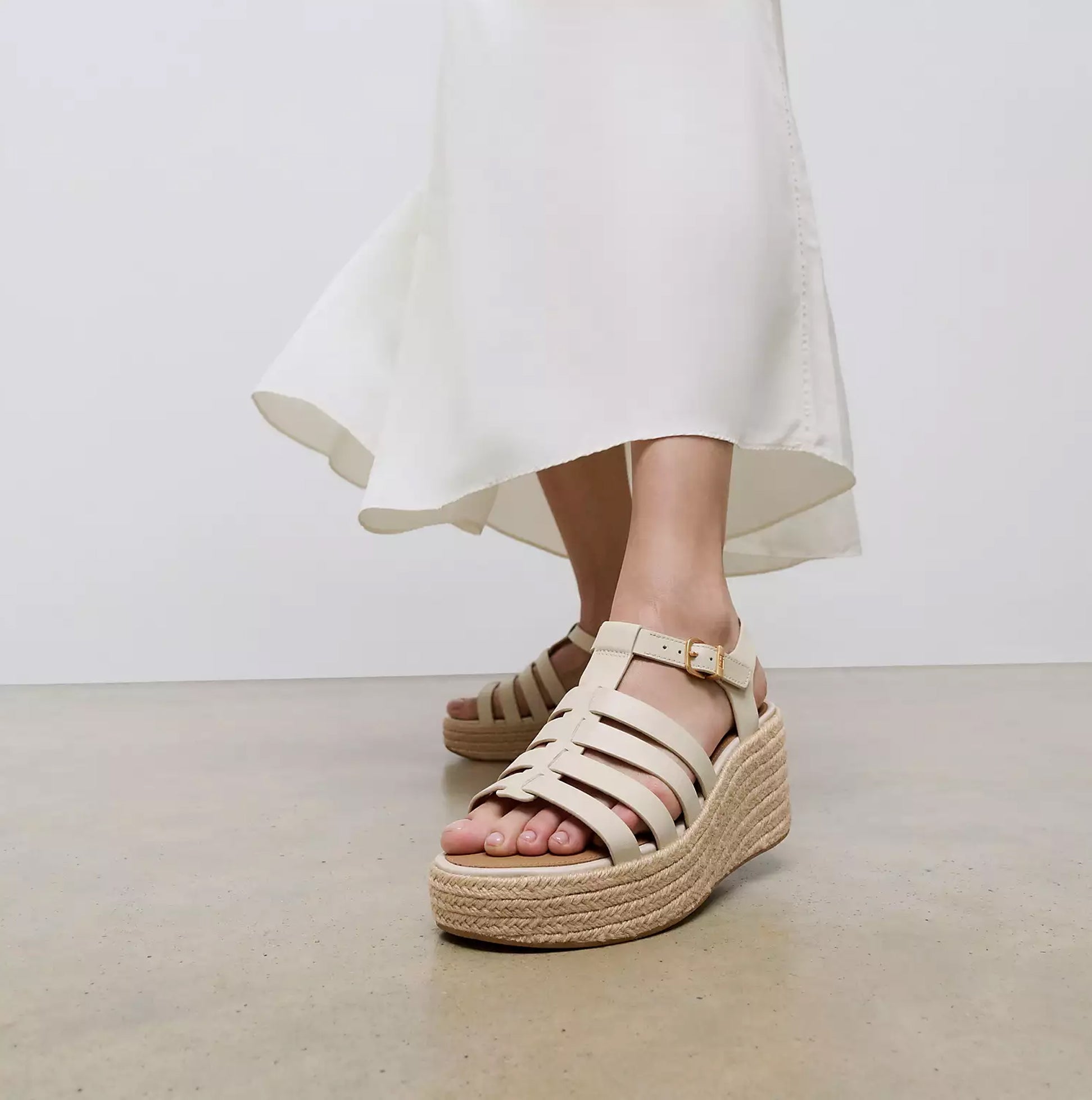 FitFlop PLATFFORMS ESPADRILLE Womens Wedge Sandals Paris Beige side view with a model wearing a flowing white dress.