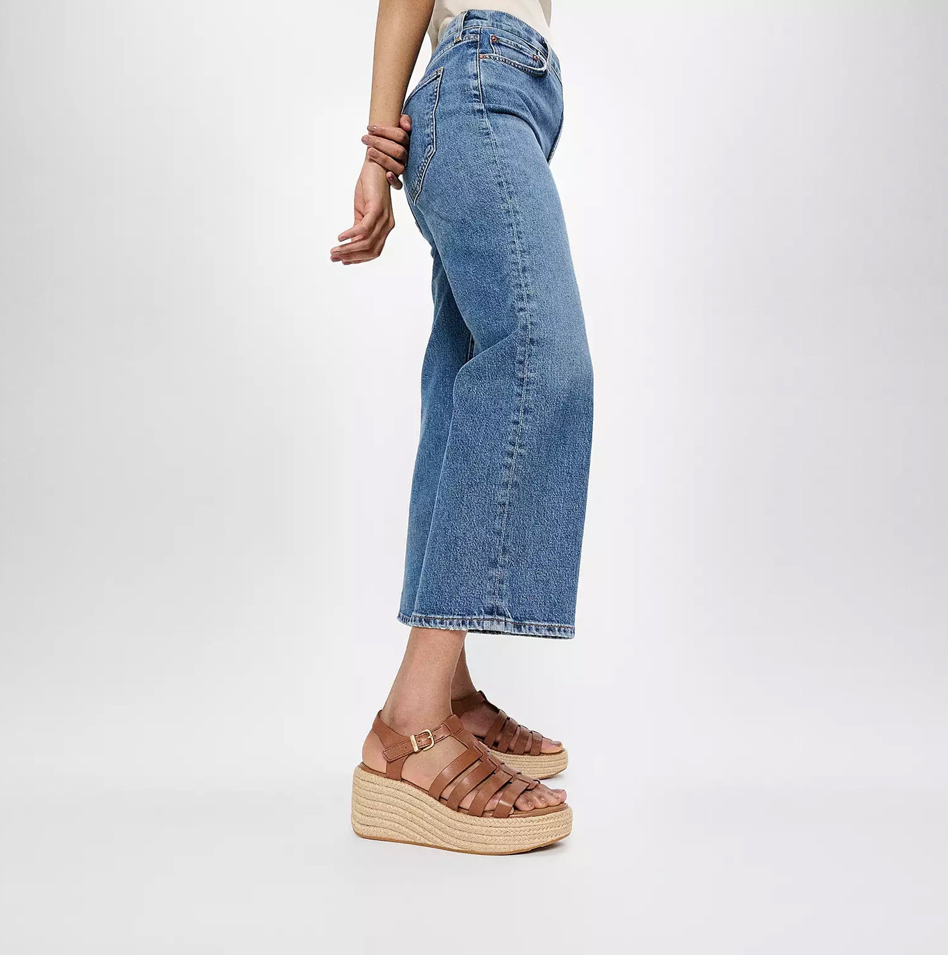 FitFlop PLATFFORMS ESPADRILLE Womens Wedge Sandals Deep Tan side view paired with jeans on a light background.