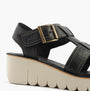 Fly London YUDD236FLY Womens Sandals Black side view showcasing leather upper, wedge heel, and buckle closure.