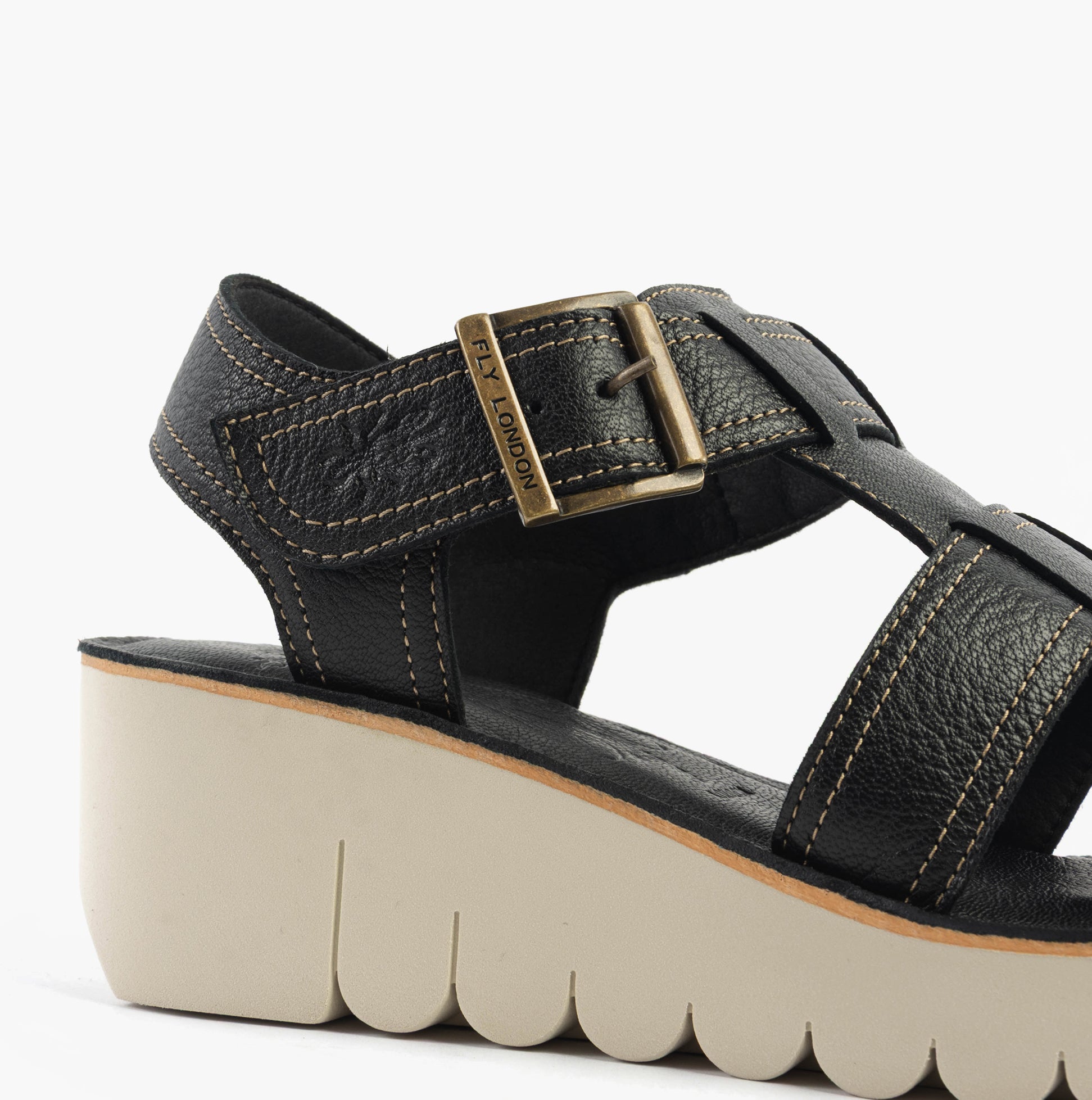 Fly London YUDD236FLY Womens Sandals Black side view showcasing leather upper, wedge heel, and buckle closure.