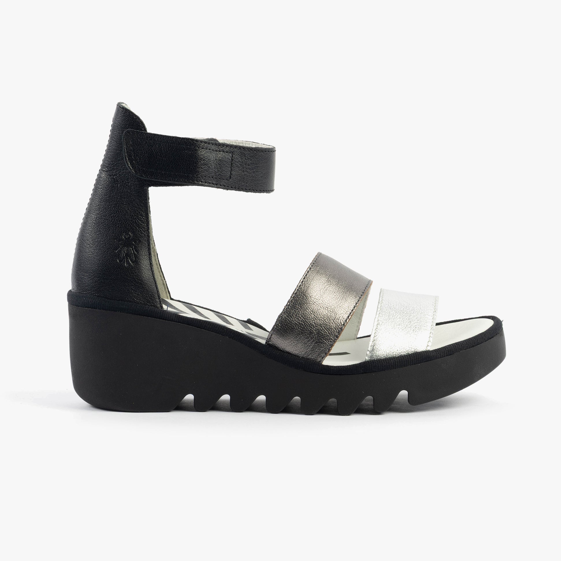 Fly London BONO290FLY Womens Sandals Silver/Graphite/Black side view showing wedge heel and leather upper material.