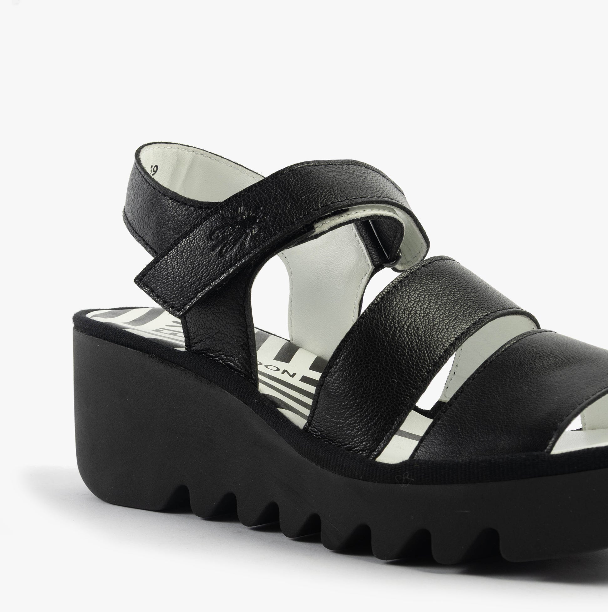 Fly London BEXY575FLY Womens Sandals Black side view showing leather upper and wedge heel