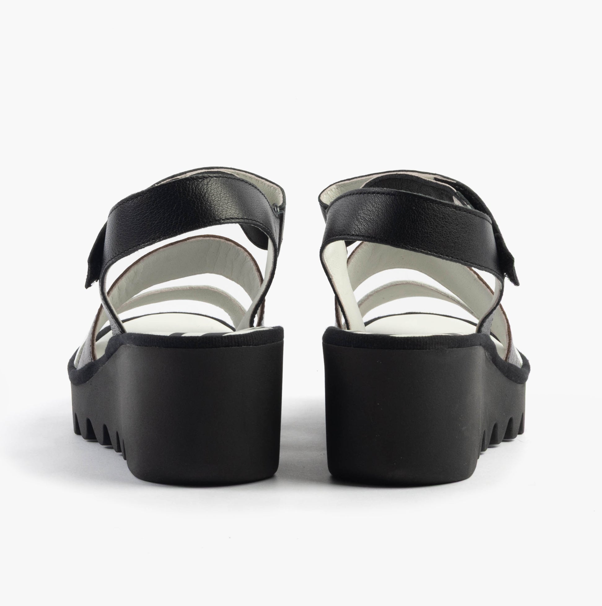 Fly London BEXY575FLY Womens Sandals Silver/Graphite/Black back view, showcasing wedge heel and leather straps.