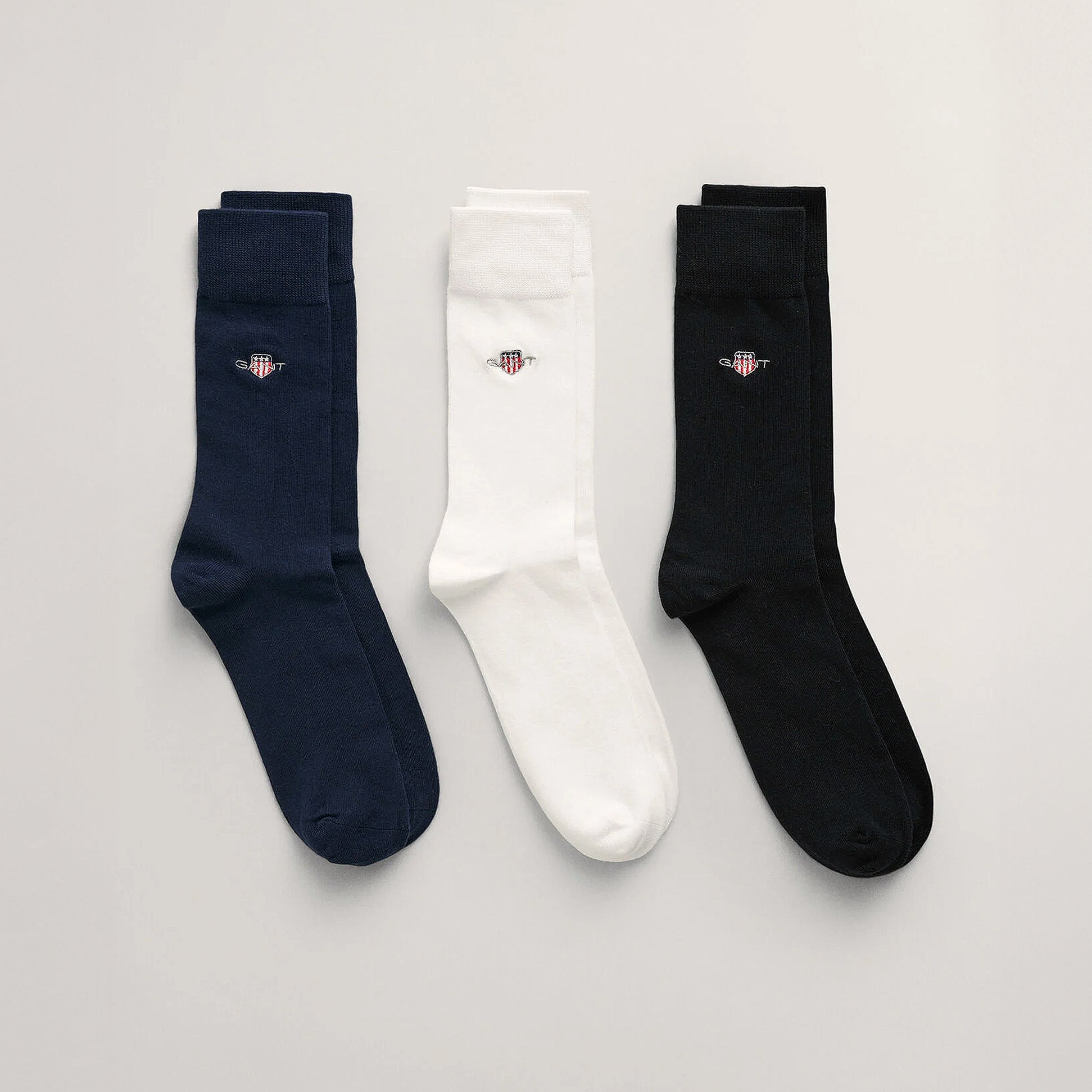 GANT SHIELD SOCKS 3-Pack Mens Black front view showing three pairs of socks in black, white, and navy blue.