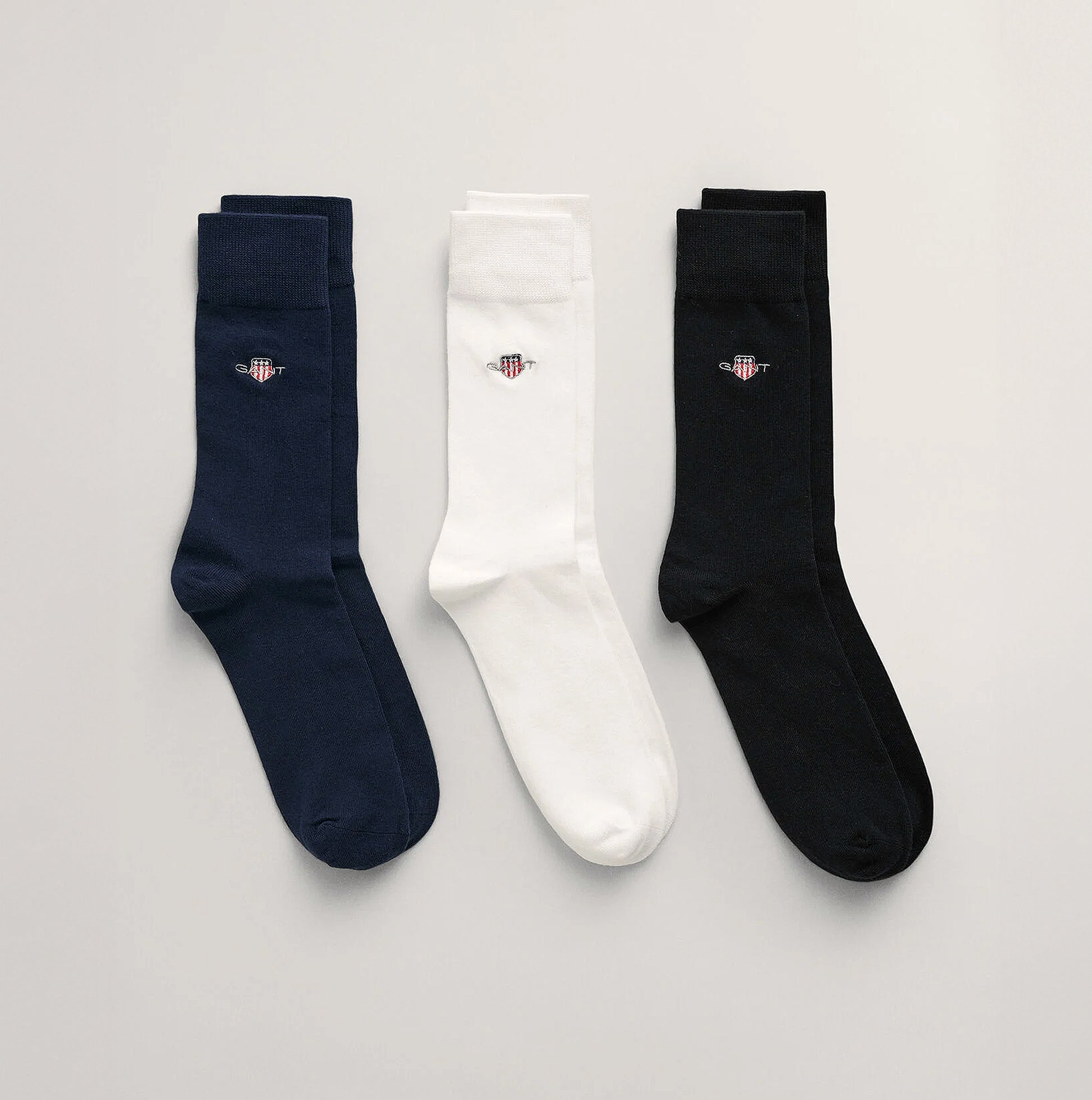GANT SHIELD SOCKS 3-Pack Mens Black front view showing three pairs of socks in black, white, and navy blue.