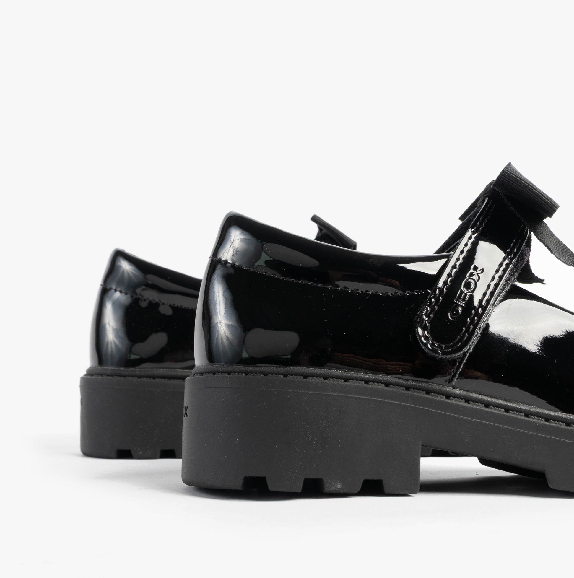 GEOX J CASEY GIRL Girls Black side view of patent leather school shoes with touch fasten closure.