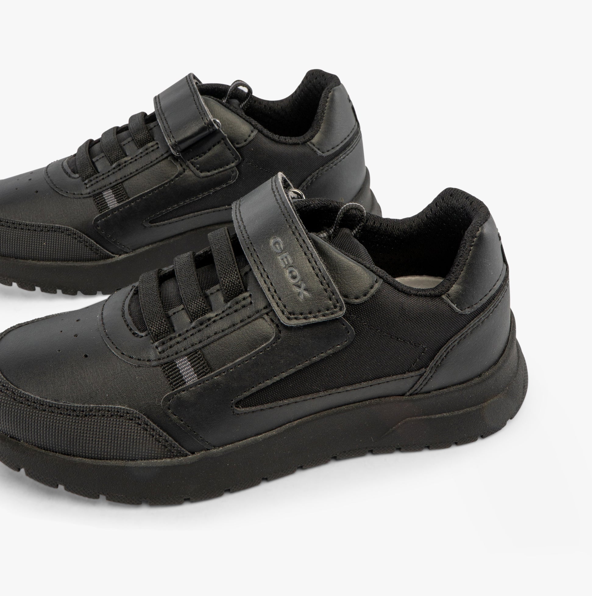 GEOX J BRIEZEE Boys Trainers Black side view showcasing synthetic leather upper and lace-up design.