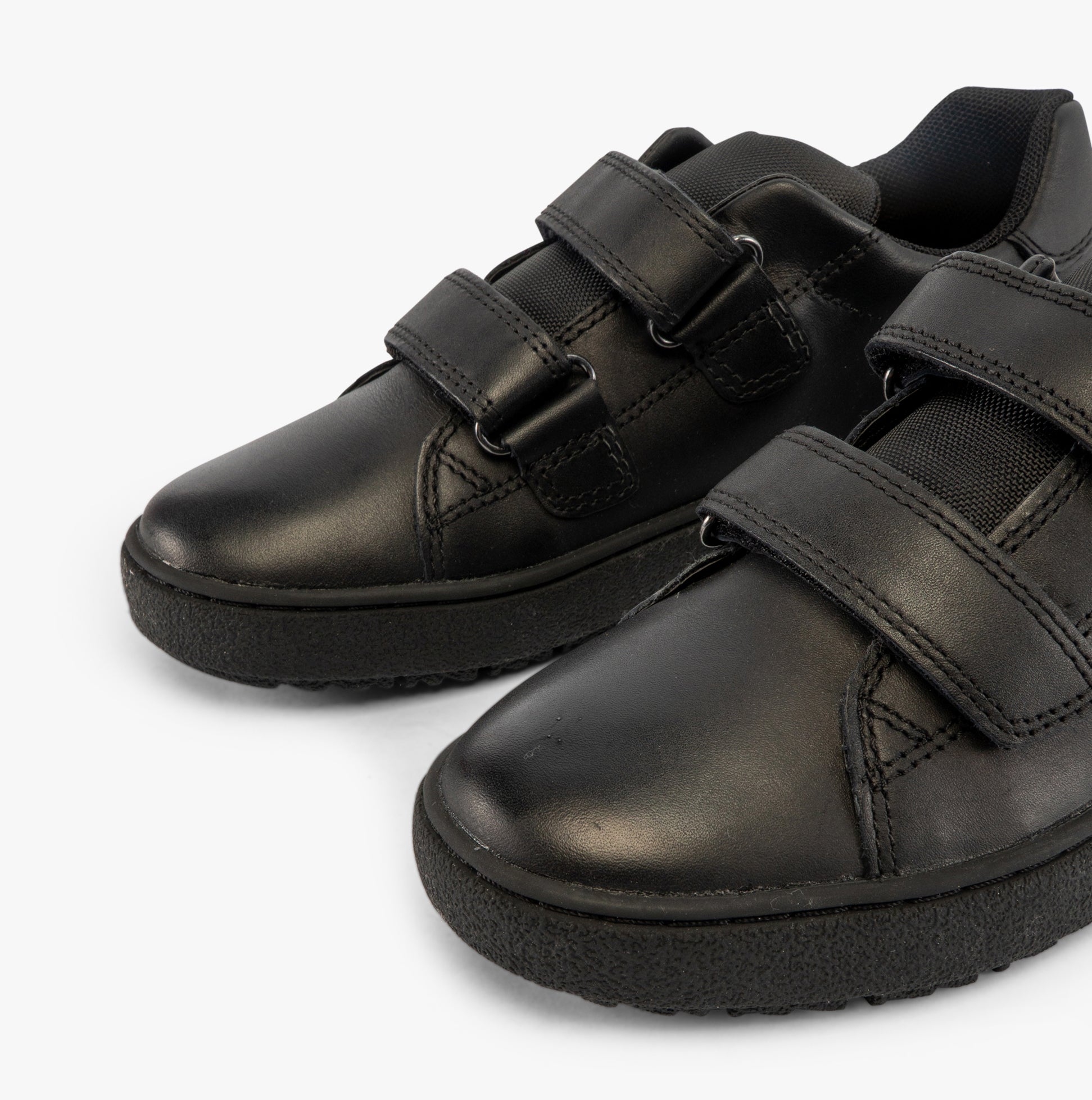 GEOX J THELEVEN Boys Trainers Black side view highlighting the touch fasten design and sleek leather upper.