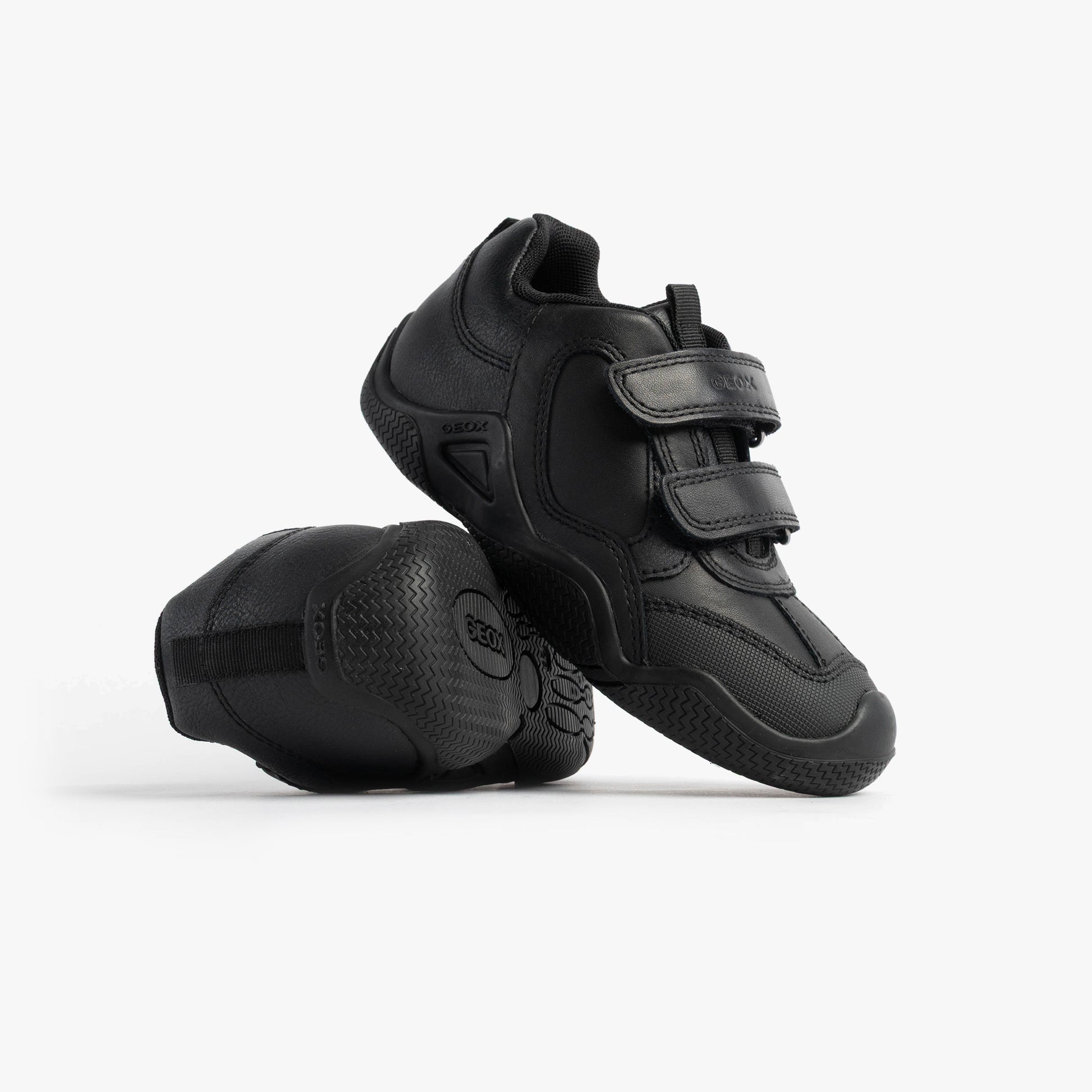 GEOX JR WADER Unisex Kids Black side view features two shoes with touch fasten closures and a rubber sole.