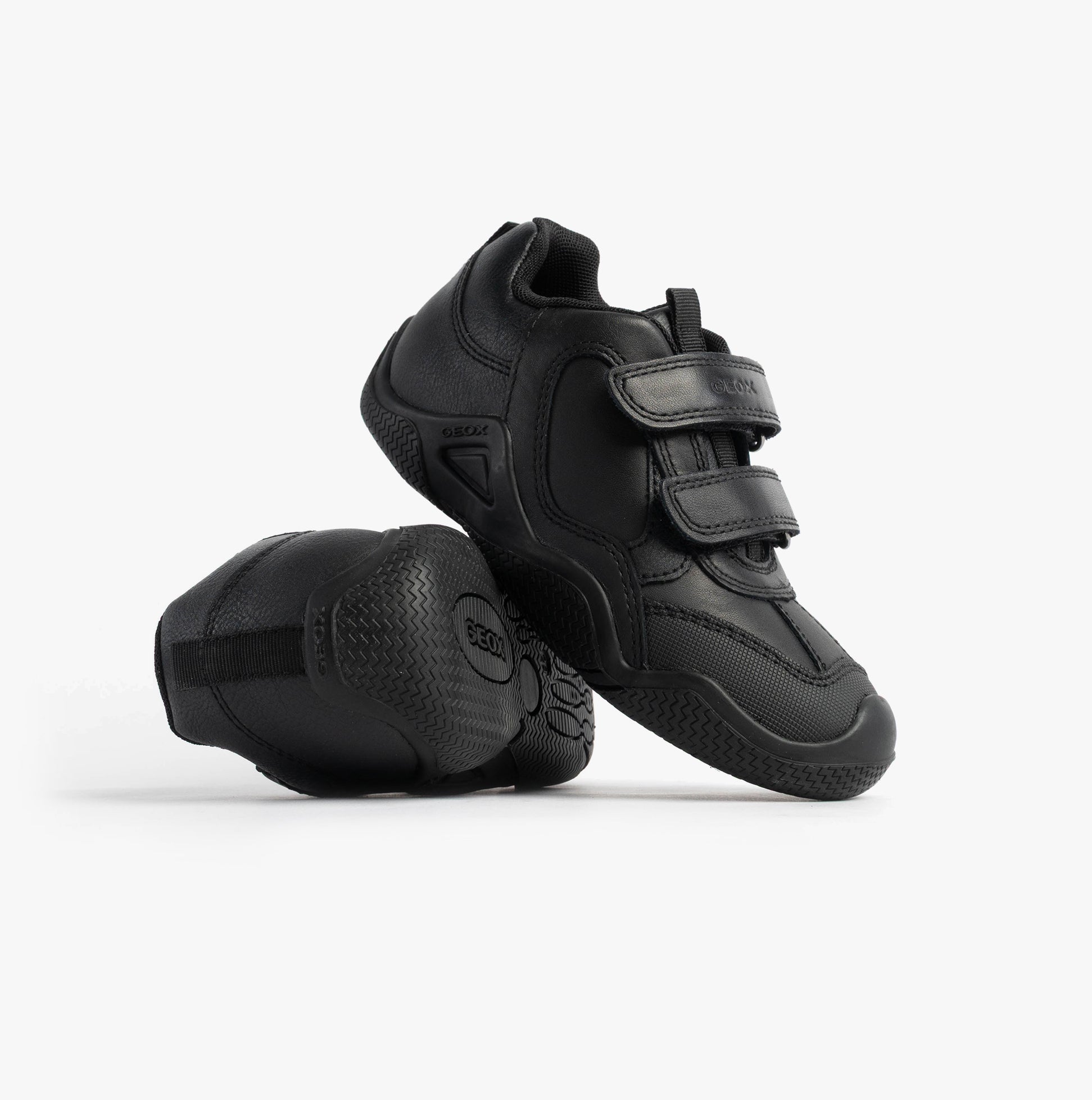 GEOX JR WADER Unisex Kids Black side view features two shoes with touch fasten closures and a rubber sole.