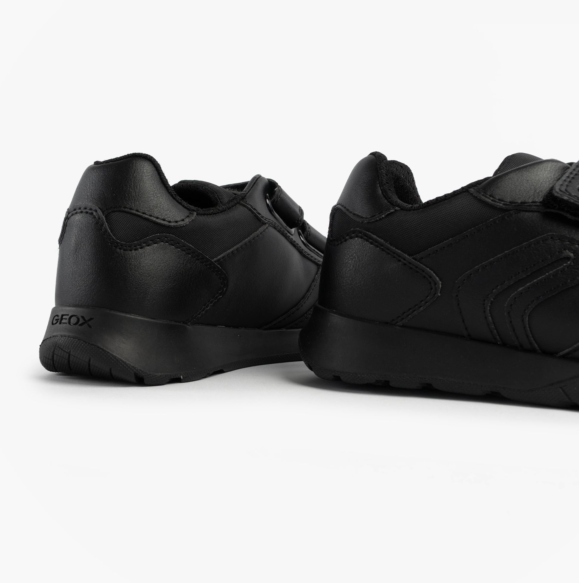 GEOX J RANN-E BOY Unisex Kids Touch Fasten Trainers Black rear angle view, showcasing synthetic upper and low top design.