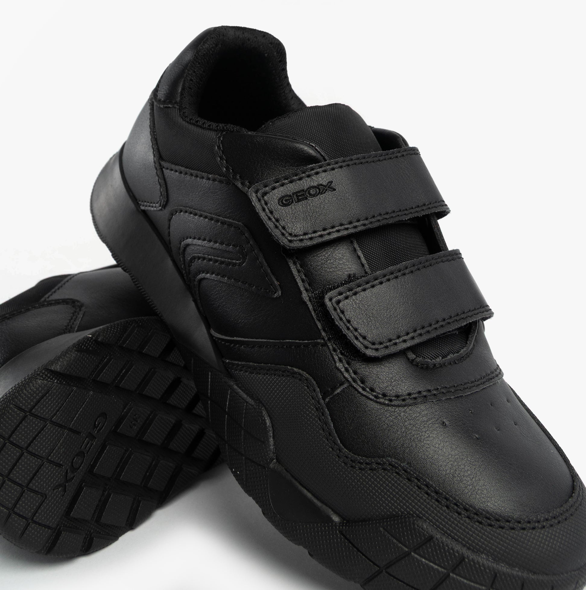 GEOX J RANN-E BOY Unisex Kids Touch Fasten Trainers Black side view showcasing the synthetic upper and riptape fastening.