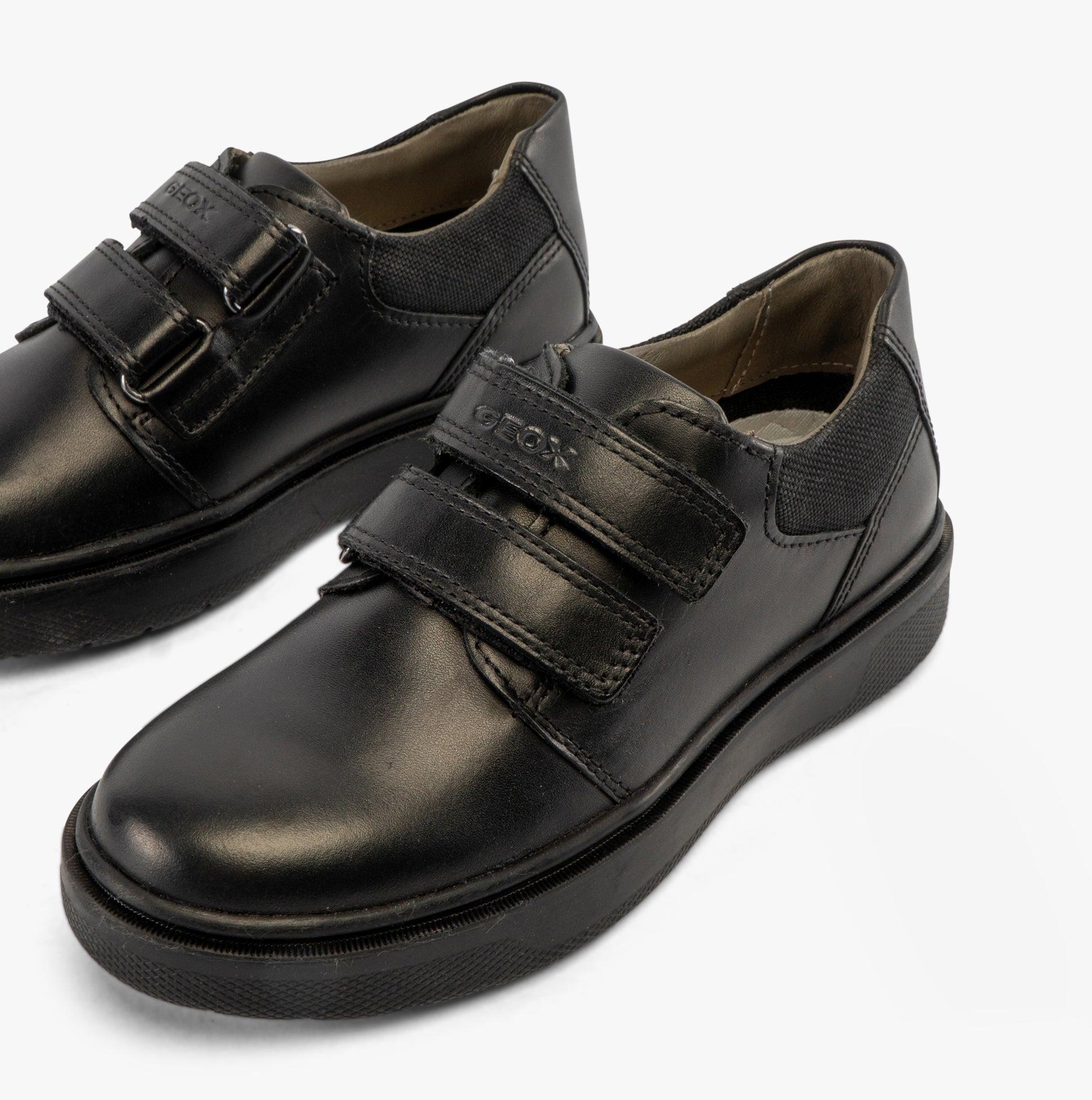 GEOX J RIDDOCK Boys Shoes Black side view showing leather upper and touch fasten closure.