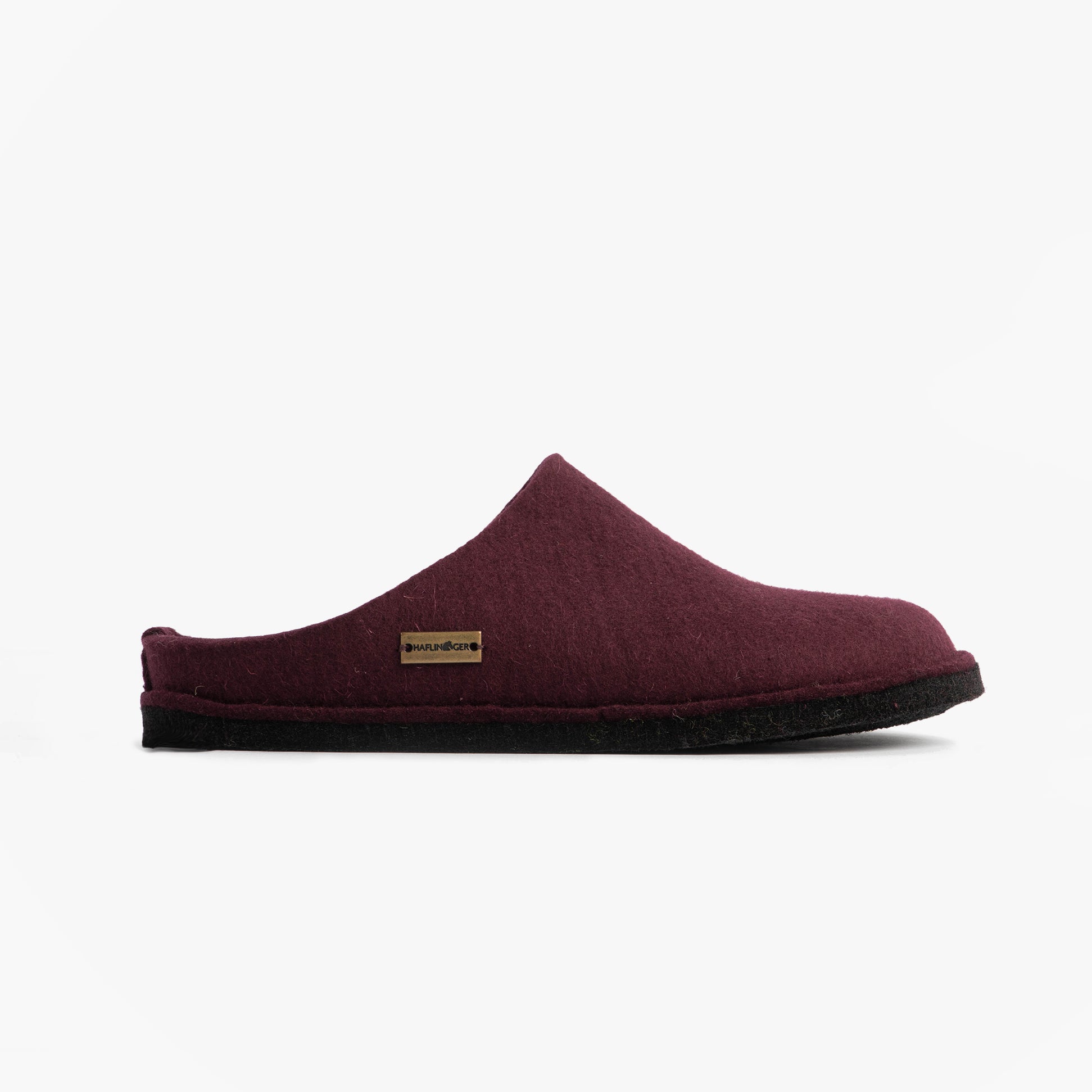 Haflinger SOFT Womens Slippers Bordeaux side view of mules with textile upper and rubber sole, showcasing slip-on style.
