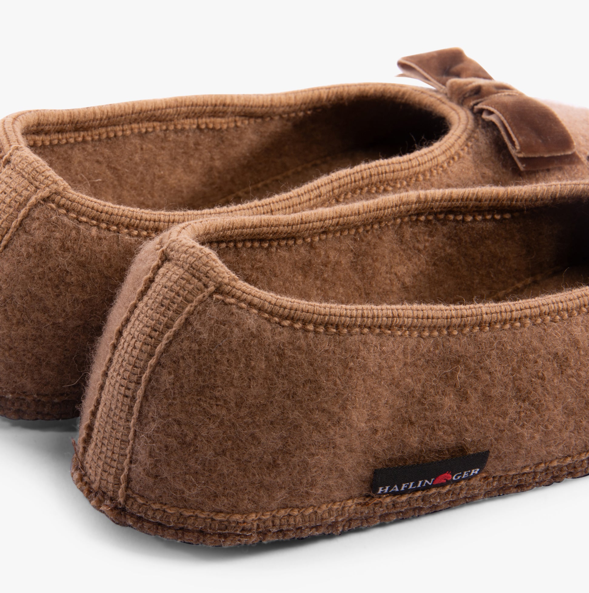 Haflinger FIOCCO Womens Slippers Camel detail view of slippers showing upper material and branding.