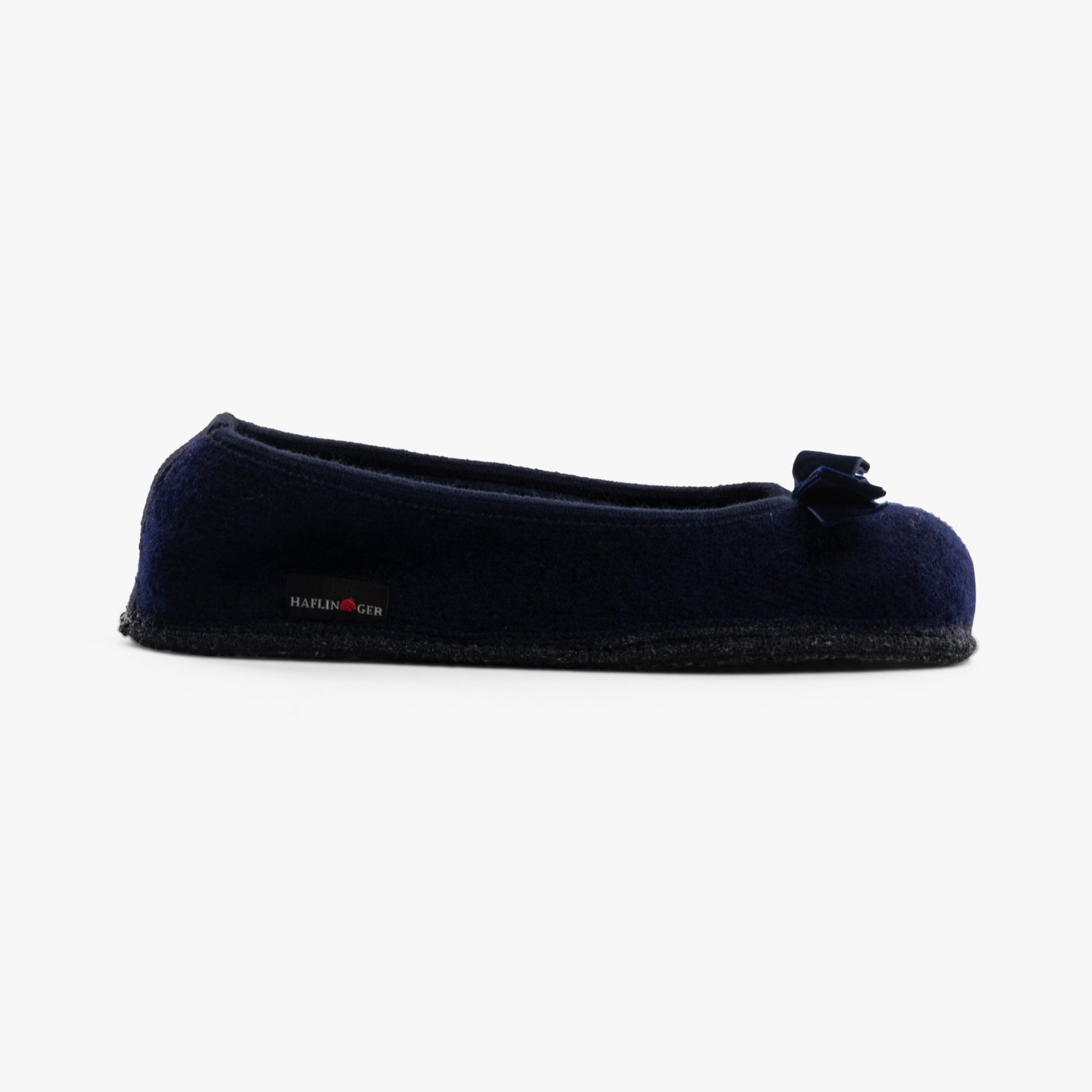 Haflinger FIOCCO Womens Slippers Navy side view with a bow detail on the toe, showcasing soft polyester upper.