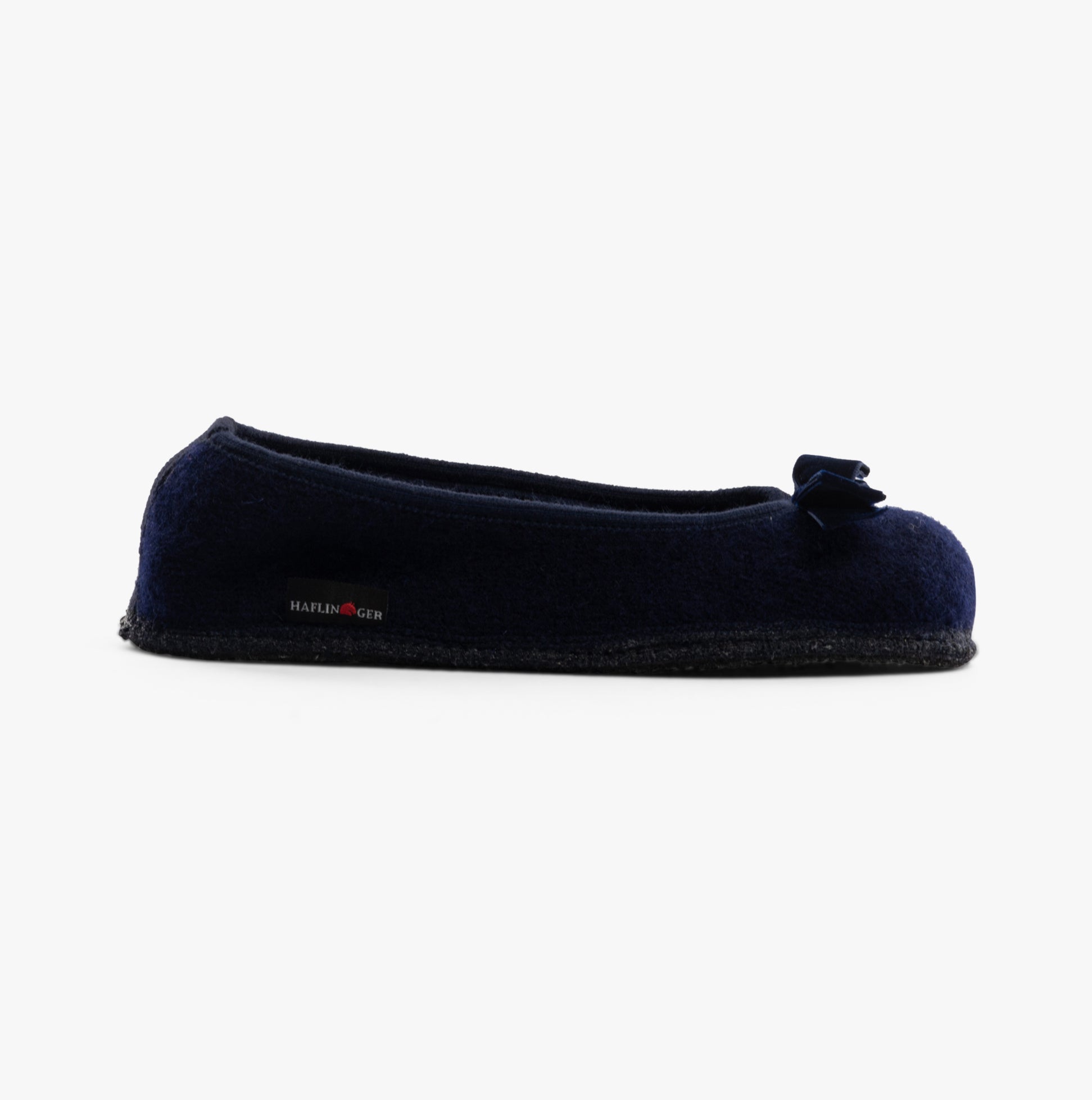 Haflinger FIOCCO Womens Slippers Navy side view with a bow detail on the toe, showcasing soft polyester upper.