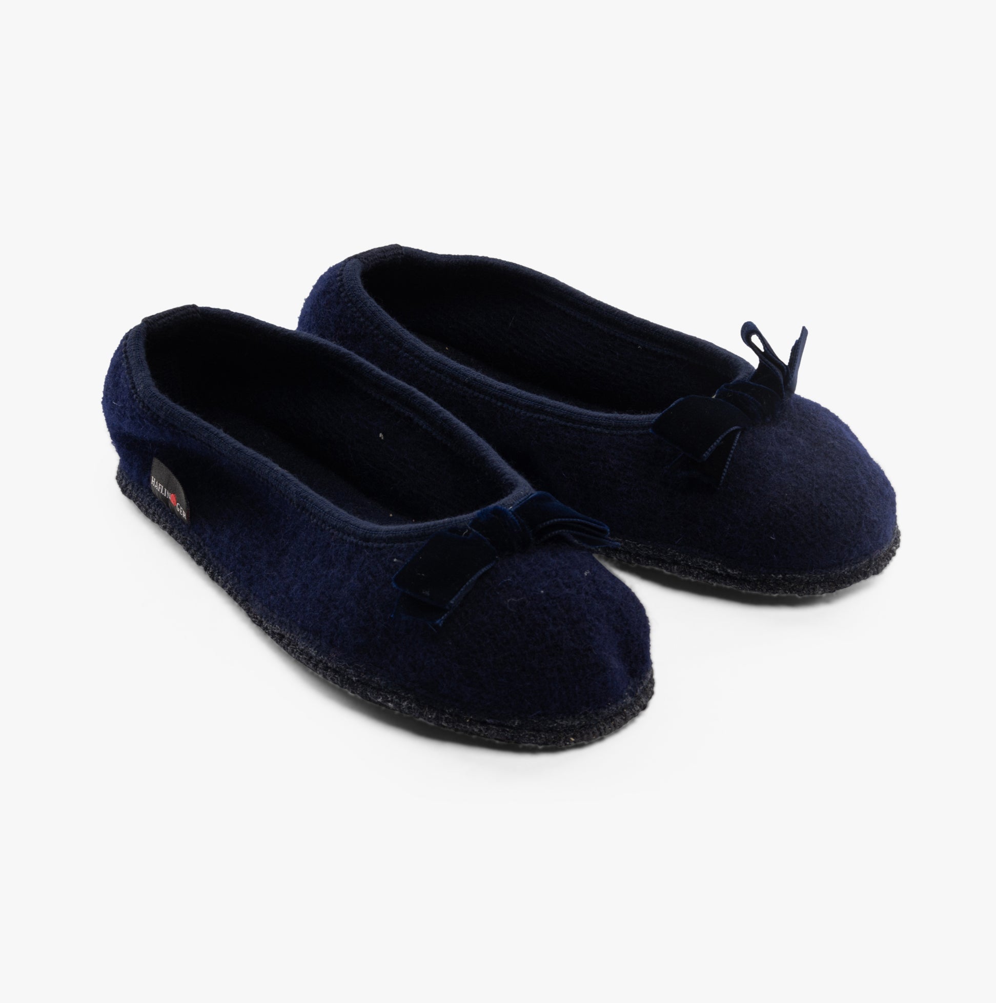 Haflinger FIOCCO Womens Slippers Navy, side view showing soft polyester material and slip-on design with bow detail.