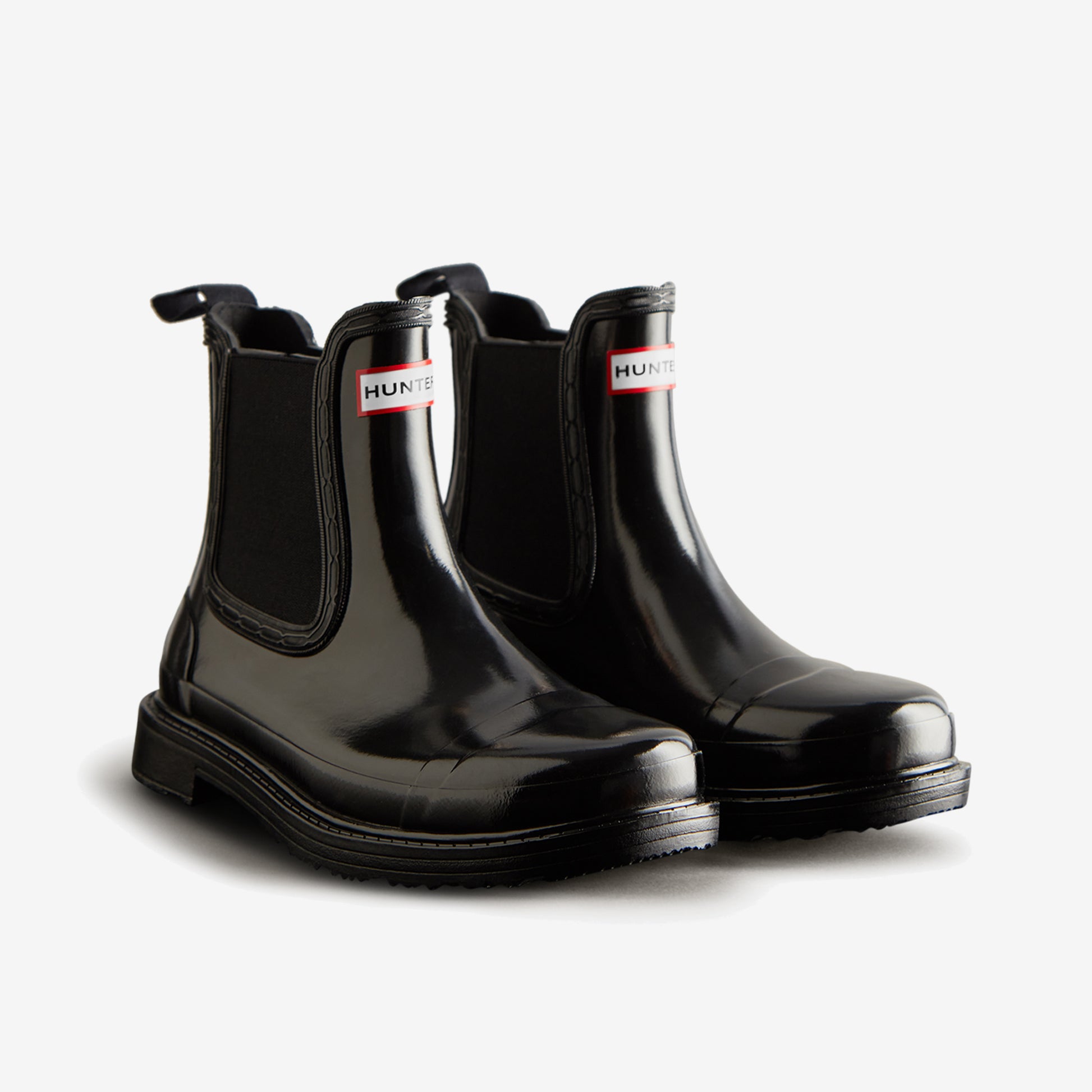 Hunter CHELSEA COMMANDO Womens Wellies Black Gloss front view showcasing stylish rubber pull-on ankle boots.