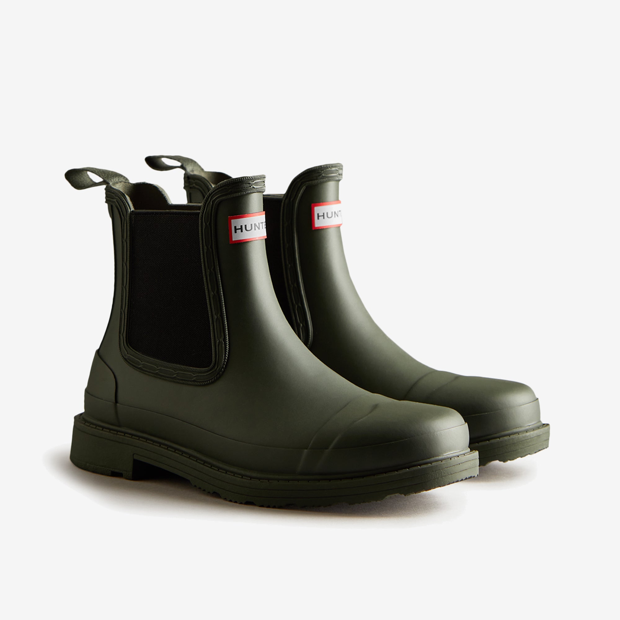Hunter CHELSEA COMMANDO Womens Wellies Dark Olive side view of ankle boots with pull-on design and rubber material.
