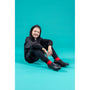 Hush Puppies BESPOKE SENIOR Boys Shoes Black side view worn by a smiling boy in a black hoodie and red socks.