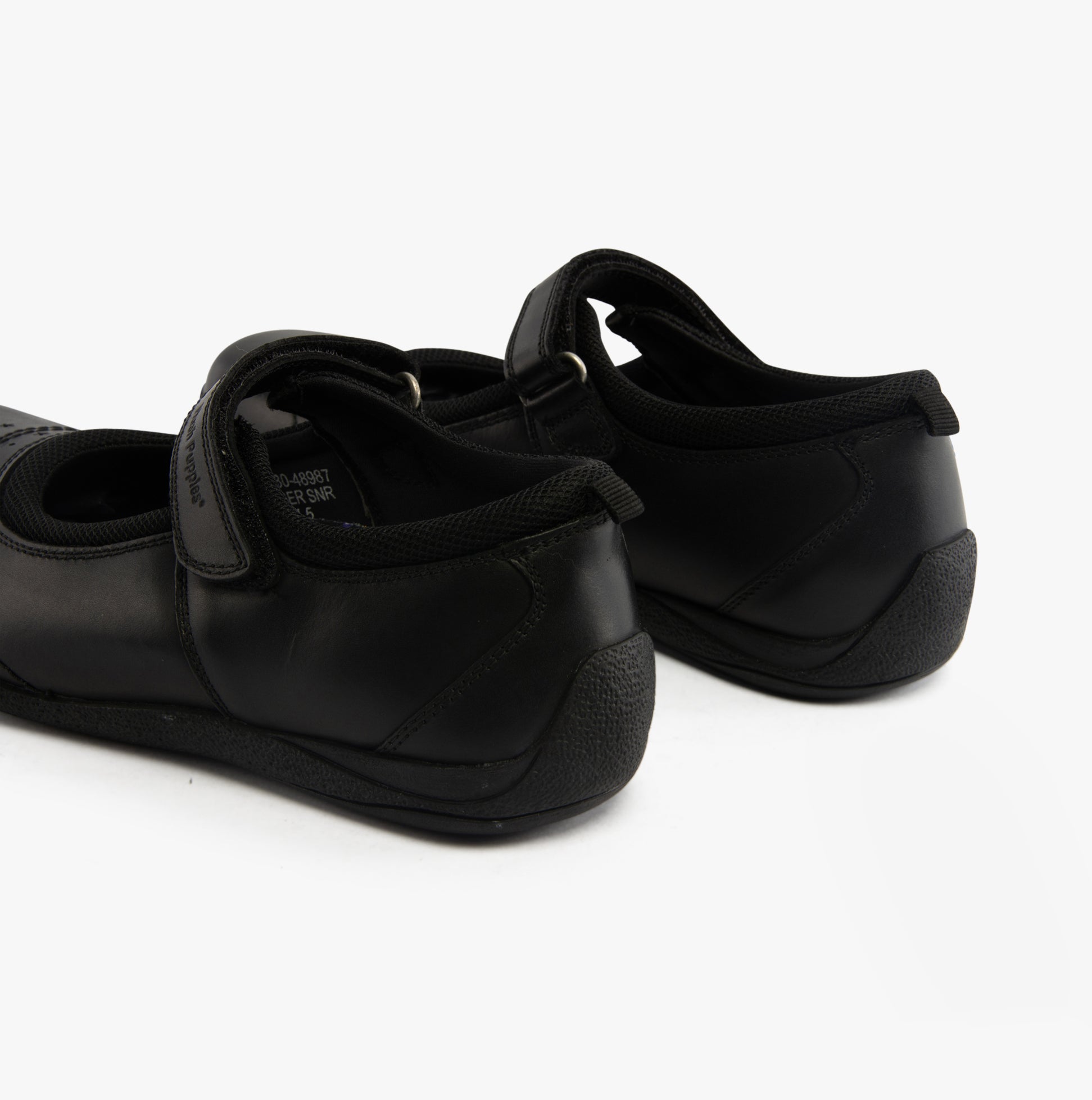 Hush Puppies AMBER JUNIOR Girls Leather School Shoes Black rear view showing adjustable strap and flat sole.