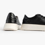 Hush Puppies CAMILLE Womens Trainers Black side view showing sleek leather upper and contrasting white sole.