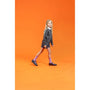 Hush Puppies BRITNEY Girls Leather School Shoes Black worn by a girl walking, side view with vibrant orange background.
