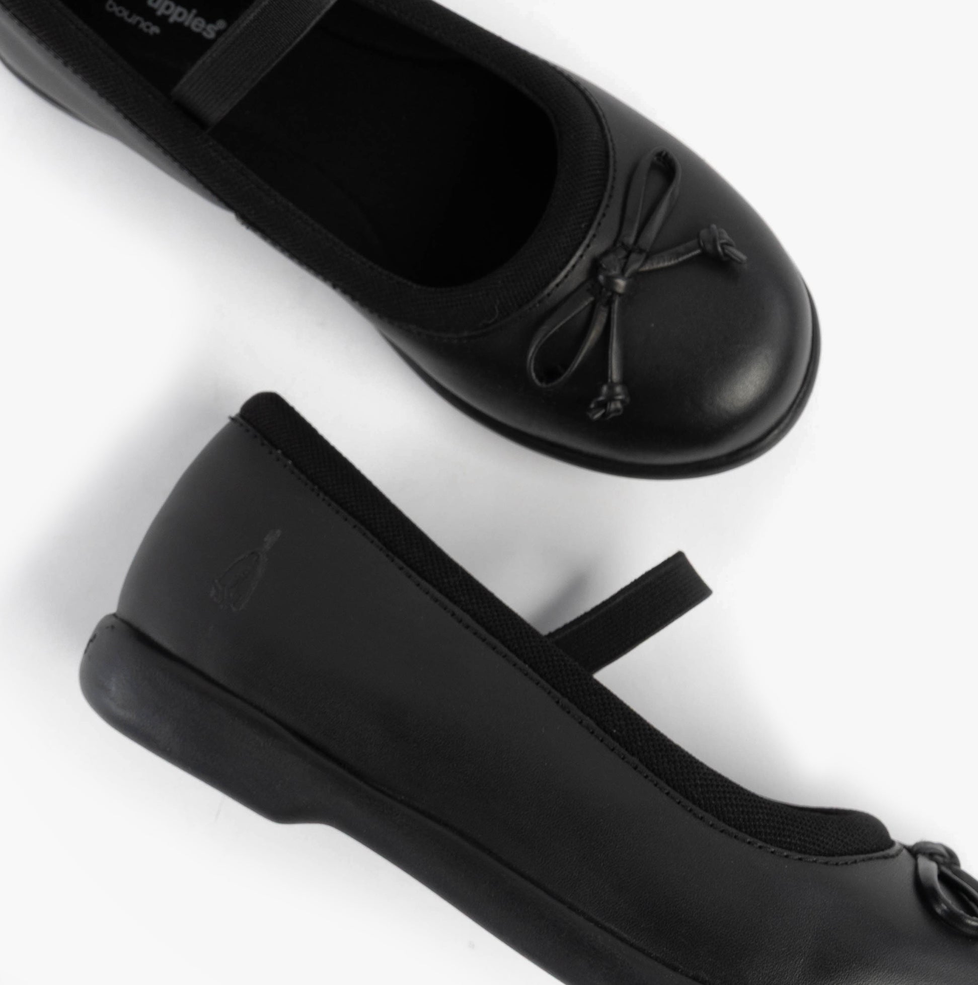 Hush Puppies BETTY JNR Girls Shoes Black top and side view showcasing slip-on design and round toe.