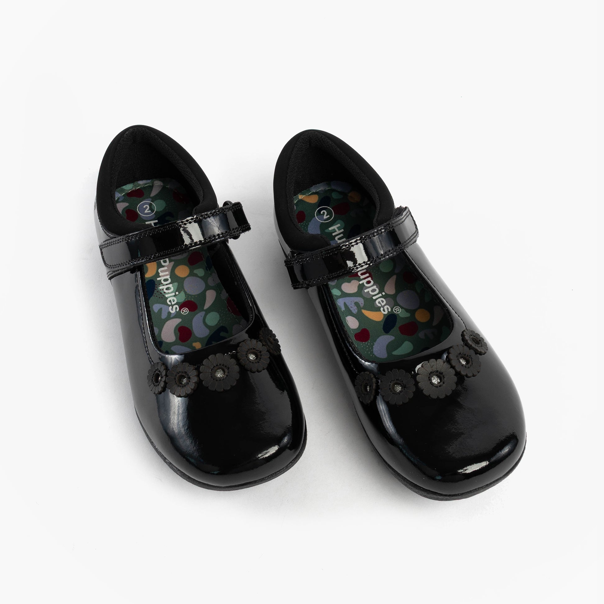 Hush Puppies CHRISTINA PATENT JUNIOR Girls Shoes Black side view showing patent leather upper and floral embellishments.